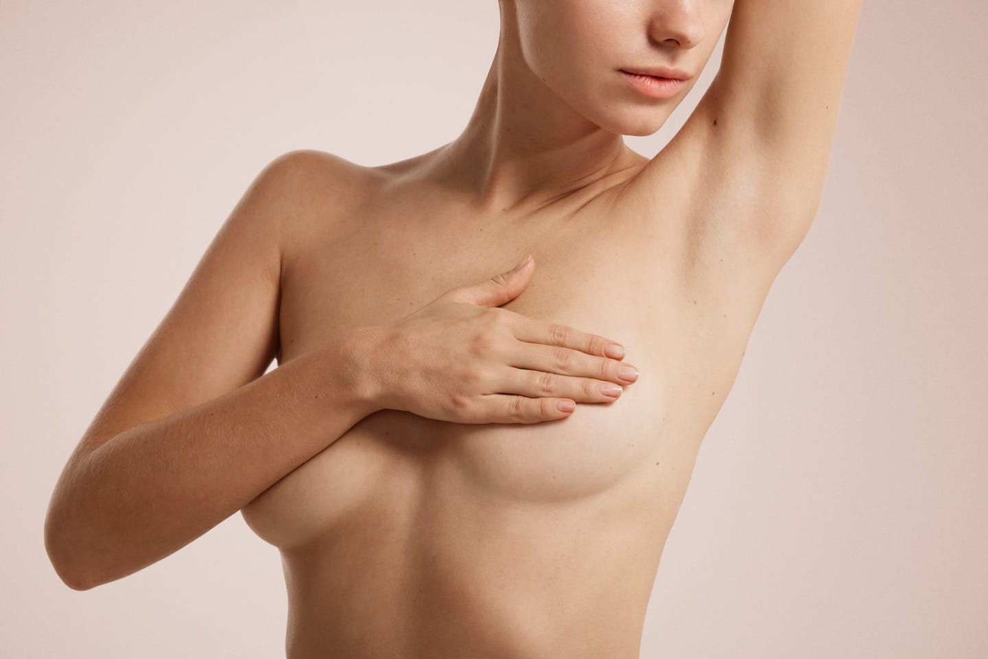 Closeup cropped portrait young woman with breast pain touching